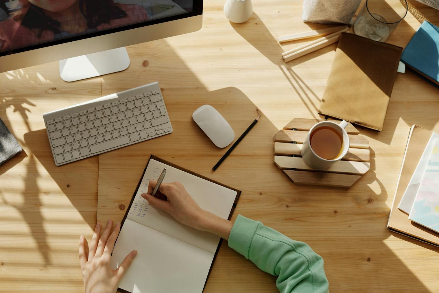 person writing on notebook